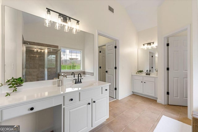 bathroom with tile patterned floors, vanity, an enclosed shower, and lofted ceiling