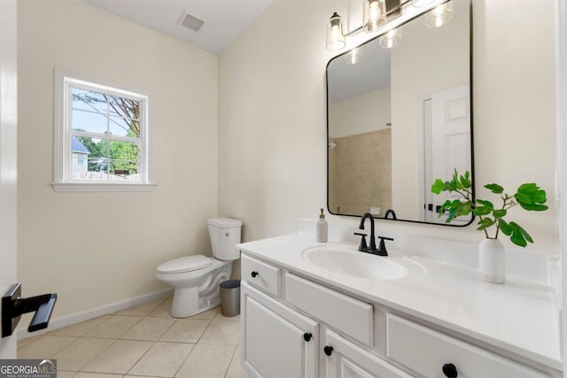 bathroom featuring tile patterned flooring, vanity, and toilet