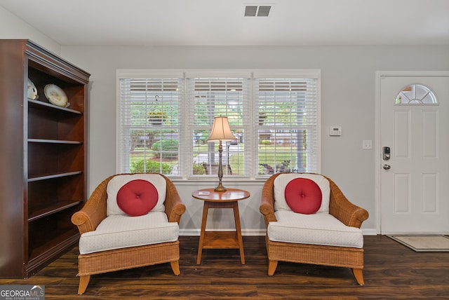 living area featuring plenty of natural light and dark hardwood / wood-style floors