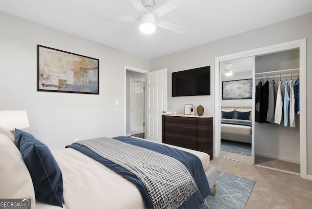 bedroom featuring ceiling fan, light colored carpet, and a closet