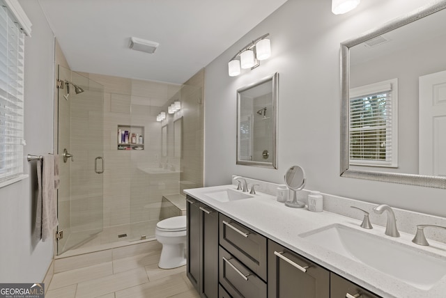 bathroom featuring vanity, an enclosed shower, and toilet