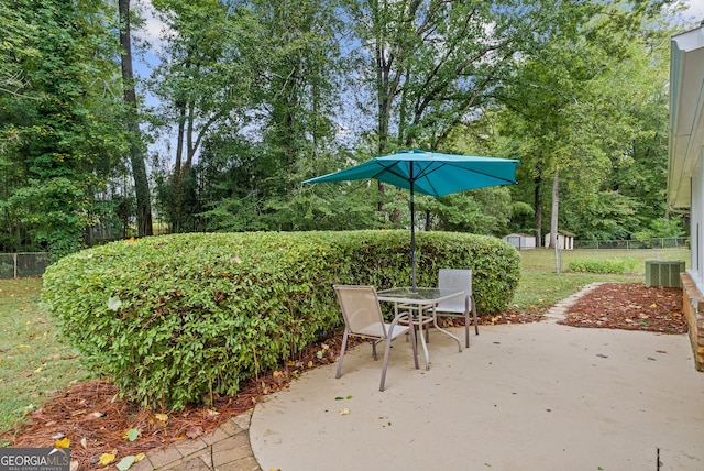 view of patio / terrace with cooling unit and a storage unit