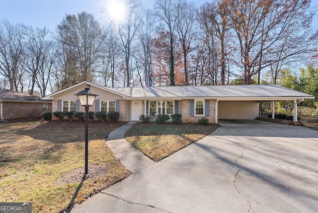 single story home featuring a front lawn and a carport