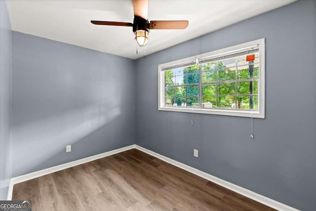 empty room featuring wood-type flooring and ceiling fan