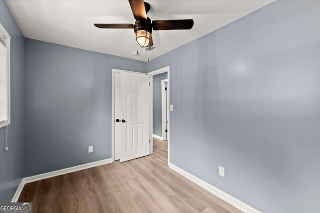 unfurnished bedroom with ceiling fan and light hardwood / wood-style flooring