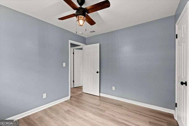 unfurnished bedroom featuring ceiling fan and light wood-type flooring