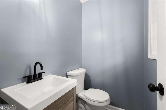 bathroom featuring vanity and toilet