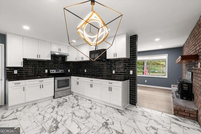 kitchen with decorative backsplash, white cabinetry, electric range, and decorative light fixtures