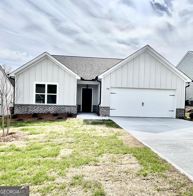 view of front of house with a garage and a front lawn