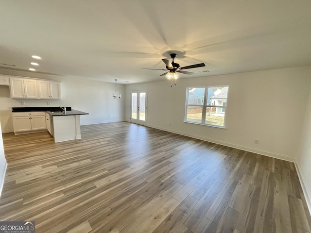 119 Savannah Way Unit C10, Milner, GA 30257 - unfurnished living room featuring light wood-style flooring, a ceiling fan, baseboards, recessed lighting, and a sink