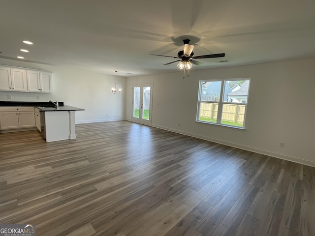 119 Savannah Way Unit C10, Milner, GA 30257 - unfurnished living room with a chandelier, dark wood finished floors, baseboards, a ceiling fan, and recessed lighting