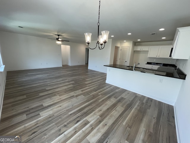 119 Savannah Way Unit C10, Milner, GA 30257 - kitchen featuring dark countertops, ceiling fan, wood finished floors, recessed lighting, and white cabinets