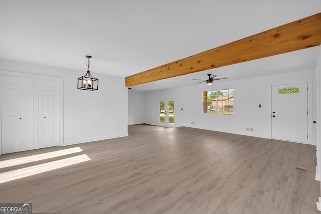 unfurnished living room featuring ceiling fan, beamed ceiling, and light hardwood / wood-style floors