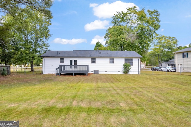 rear view of property featuring central AC, a deck, and a yard