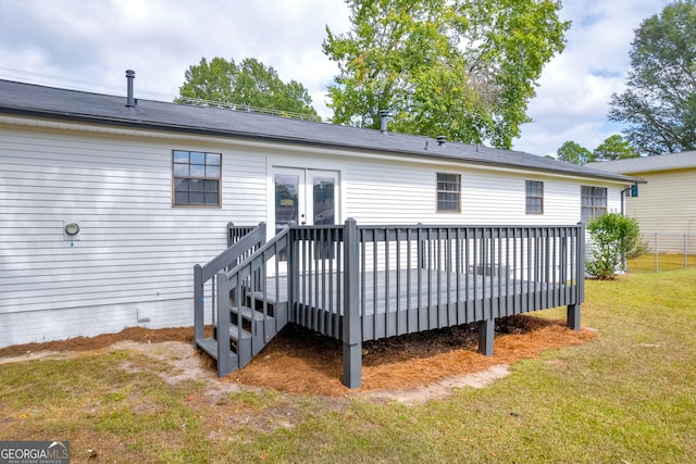 rear view of house with a lawn and a deck