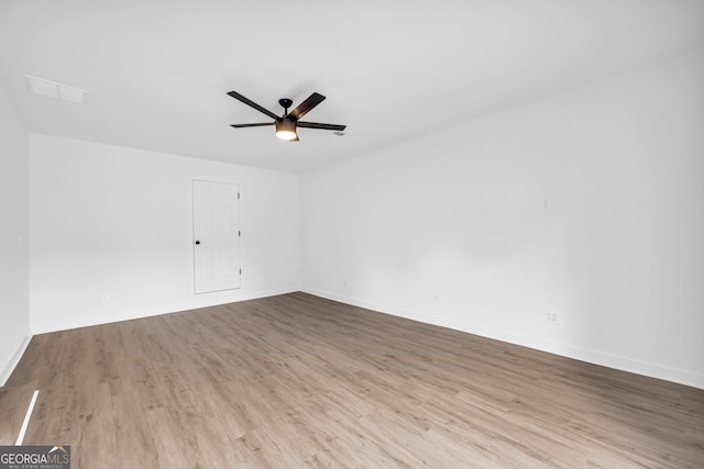 empty room with ceiling fan and light wood-type flooring