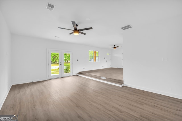 unfurnished room featuring wood-type flooring, ceiling fan, and french doors