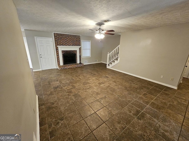 unfurnished living room featuring visible vents, a ceiling fan, stairway, a fireplace, and baseboards