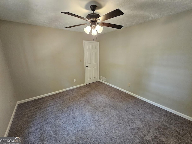 unfurnished room featuring visible vents, a textured ceiling, carpet, and baseboards