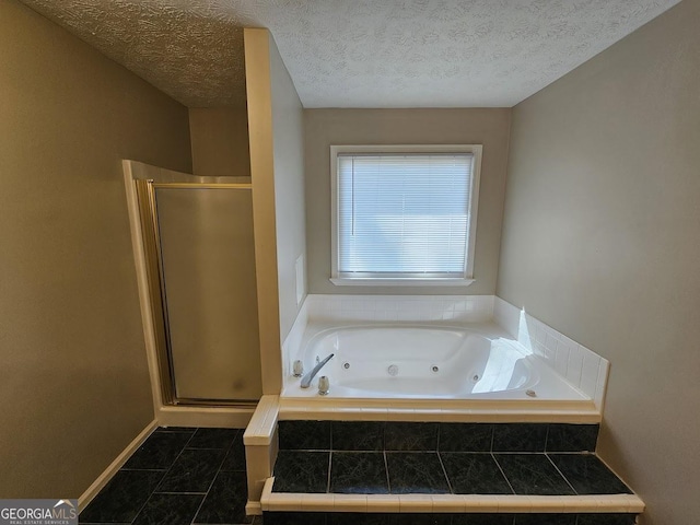 bathroom featuring a shower stall, a textured ceiling, and a whirlpool tub