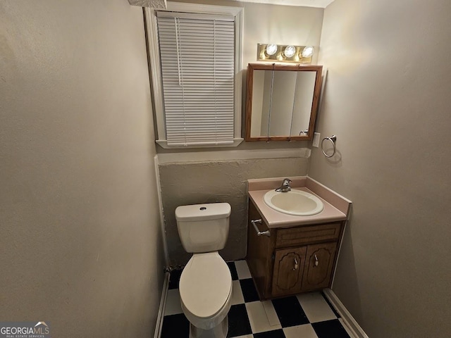 bathroom featuring vanity, tile patterned floors, and toilet