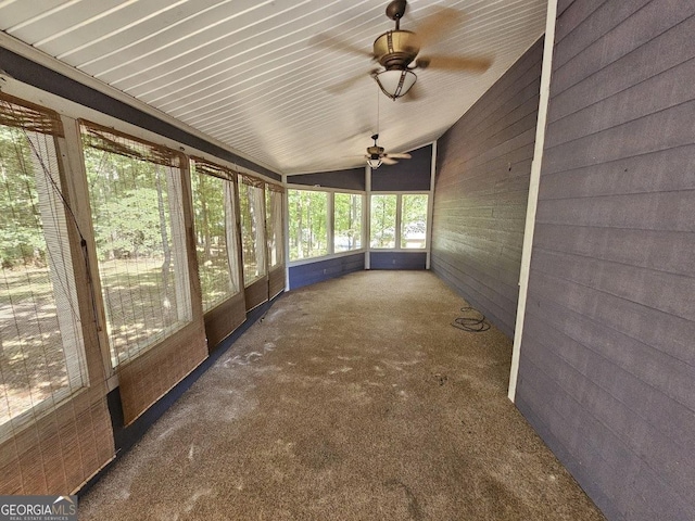 unfurnished sunroom with a ceiling fan and lofted ceiling