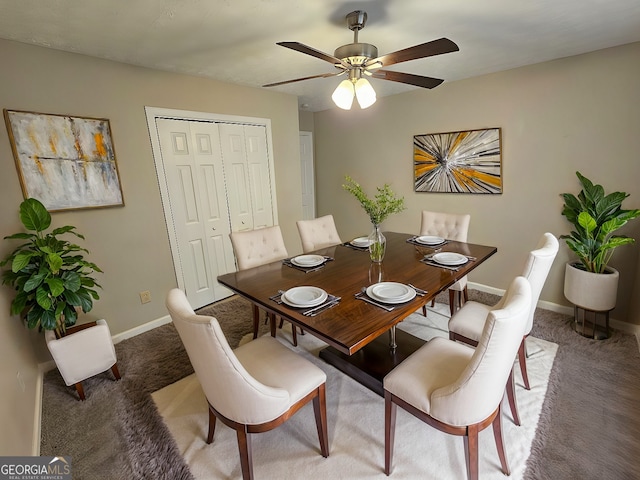 dining area featuring baseboards, carpet, and a ceiling fan