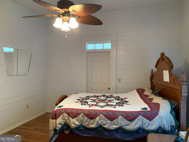 bedroom with ceiling fan and hardwood / wood-style flooring