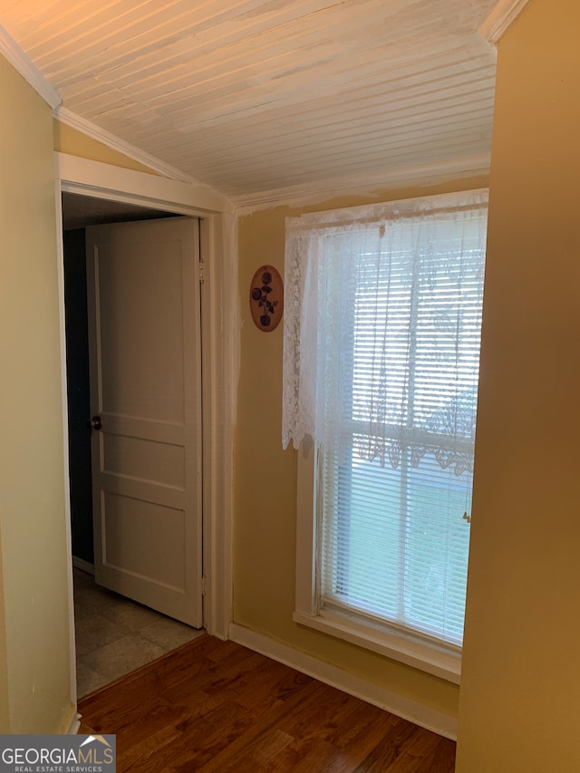 hall with wooden ceiling, ornamental molding, hardwood / wood-style floors, and vaulted ceiling