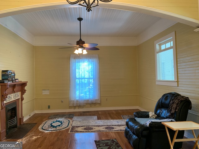 living area featuring dark hardwood / wood-style floors, ceiling fan, and a wealth of natural light