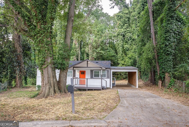 view of front of house with a carport and a deck