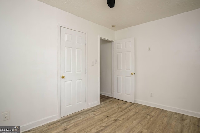 unfurnished bedroom with light hardwood / wood-style floors and ceiling fan