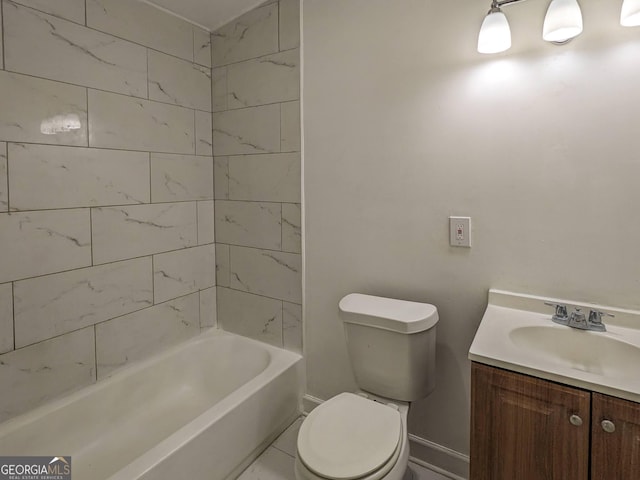 full bathroom with tiled shower / bath, vanity, and toilet