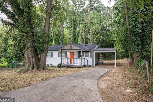 ranch-style house with a carport and a wooden deck