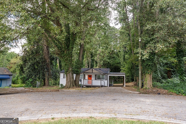 view of front of house featuring a carport and a porch