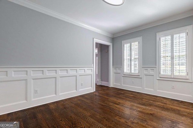 spare room with ornamental molding and dark hardwood / wood-style flooring