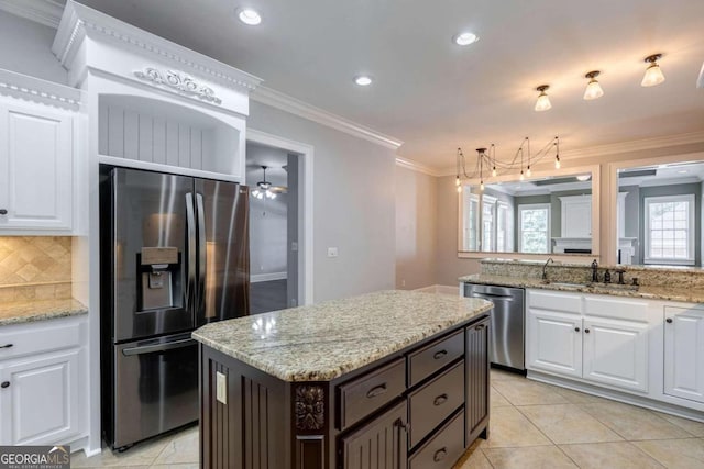 kitchen with dark brown cabinetry, stainless steel appliances, tasteful backsplash, and white cabinetry