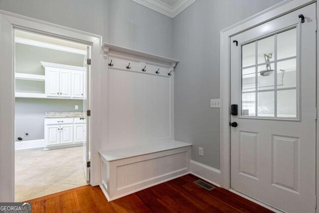 mudroom featuring wood-type flooring and ornamental molding