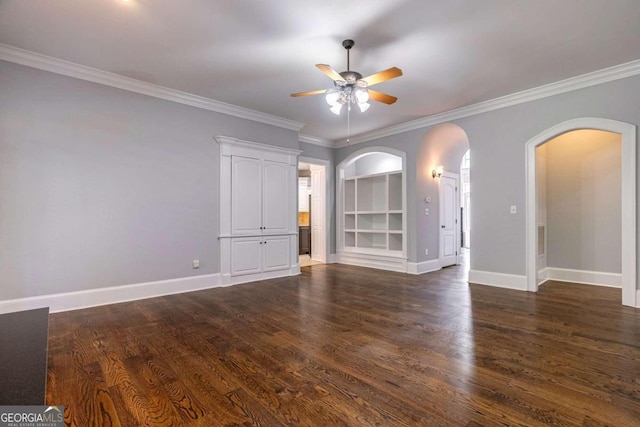 spare room with ceiling fan, crown molding, and dark wood-type flooring