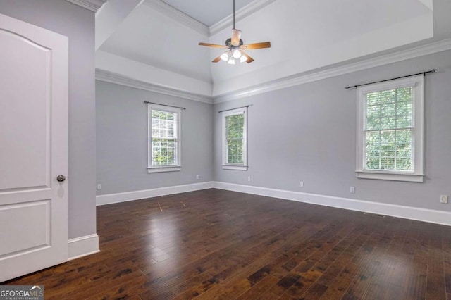 spare room with ornamental molding, a wealth of natural light, ceiling fan, and dark hardwood / wood-style floors