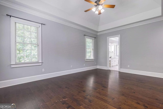 empty room featuring ceiling fan, vaulted ceiling, crown molding, and dark hardwood / wood-style flooring