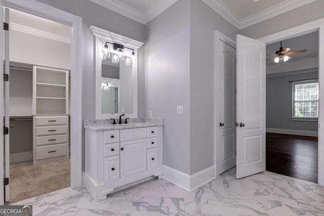 bathroom featuring ceiling fan, vanity, and ornamental molding