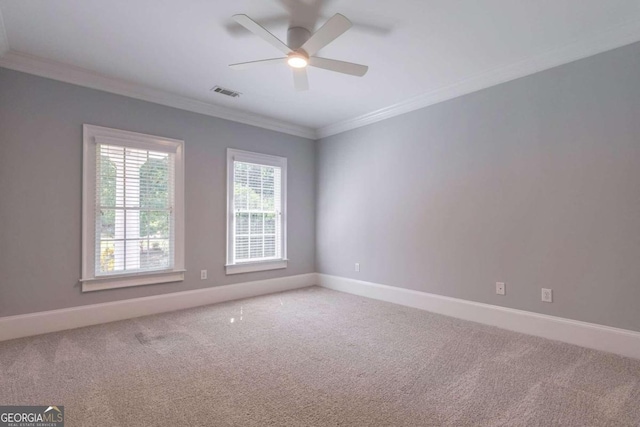 spare room with carpet floors, ornamental molding, and ceiling fan