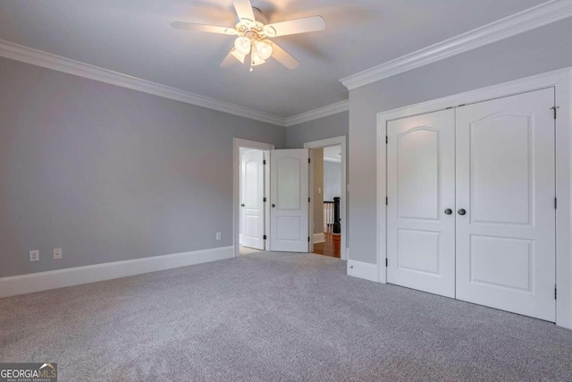 unfurnished bedroom featuring ceiling fan, carpet floors, a closet, and ornamental molding