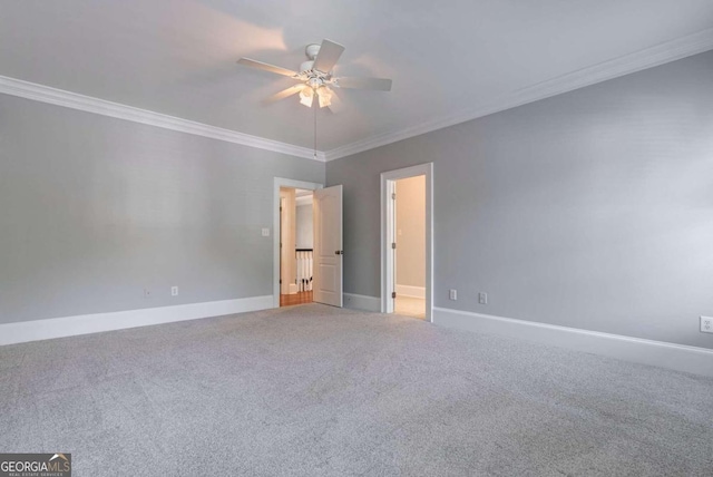 unfurnished bedroom featuring ornamental molding, ceiling fan, and carpet floors