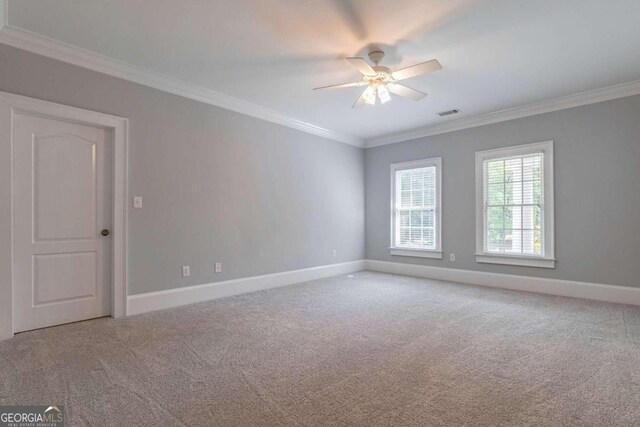 carpeted spare room with ornamental molding and ceiling fan