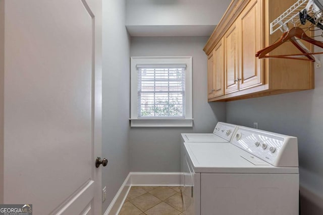 washroom with cabinets, light tile patterned floors, and washer and dryer