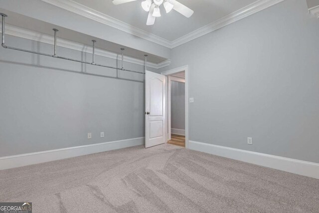 unfurnished bedroom featuring ceiling fan, carpet floors, a closet, and crown molding