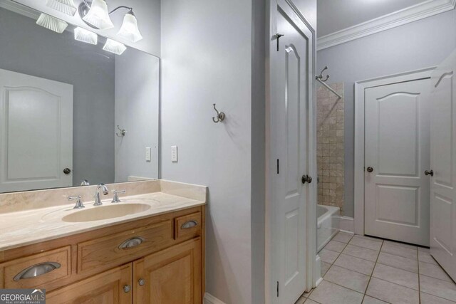 bathroom featuring crown molding, vanity, and tiled shower / bath