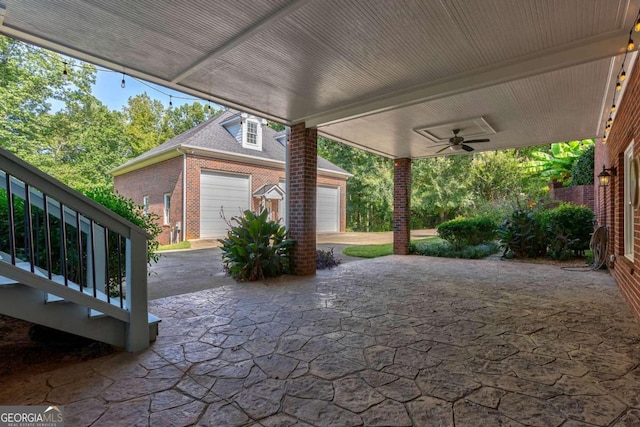 view of patio with a garage and ceiling fan